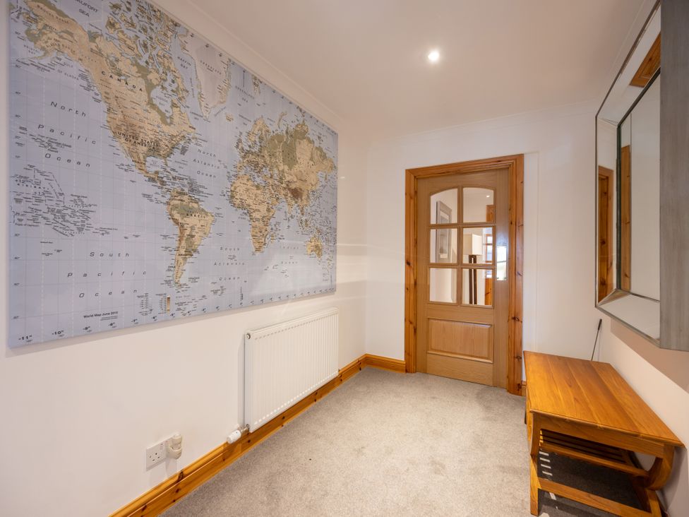 A hallway with a world map on the wall at Old Distillery Lodge