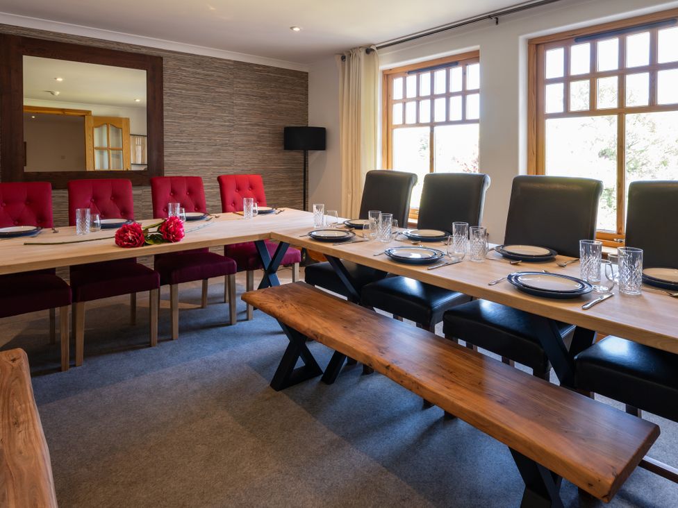 A dining room with a large table set for a meal at Old Distillery Lodge