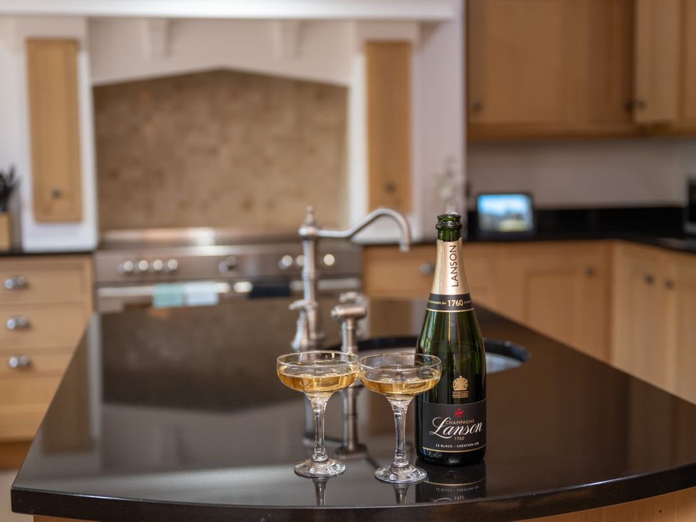 A kitchen with champagne and glasses on the counter at Old Distillery Lodge