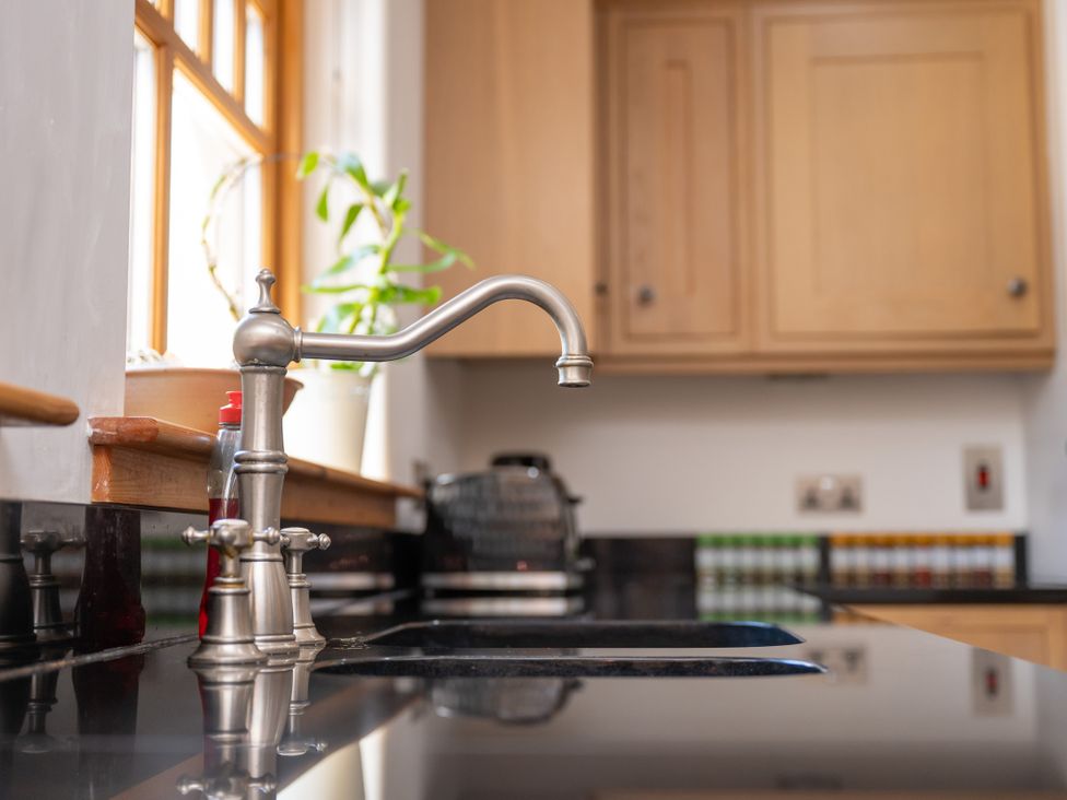 A kitchen with a sink and faucet at Old Distillery Lodge