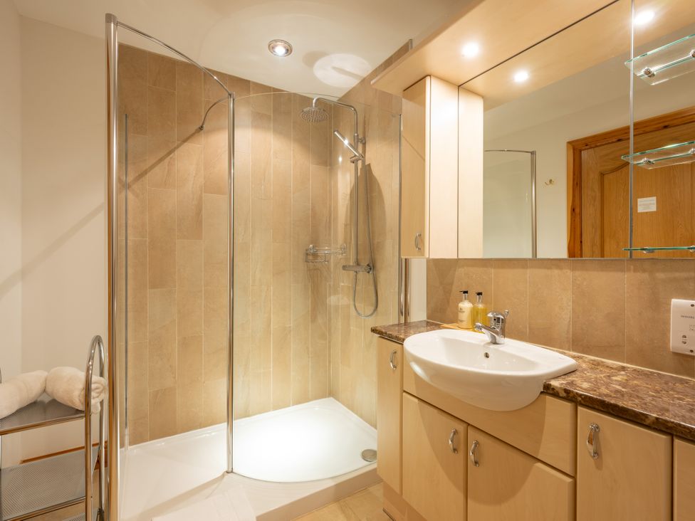 A bathroom with a shower and sink at Old Distillery Lodge 
