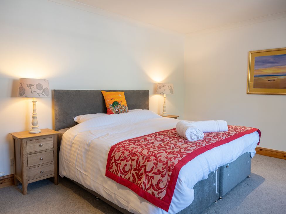 A bedroom with a bed and bedside tables at Old Distillery Lodge