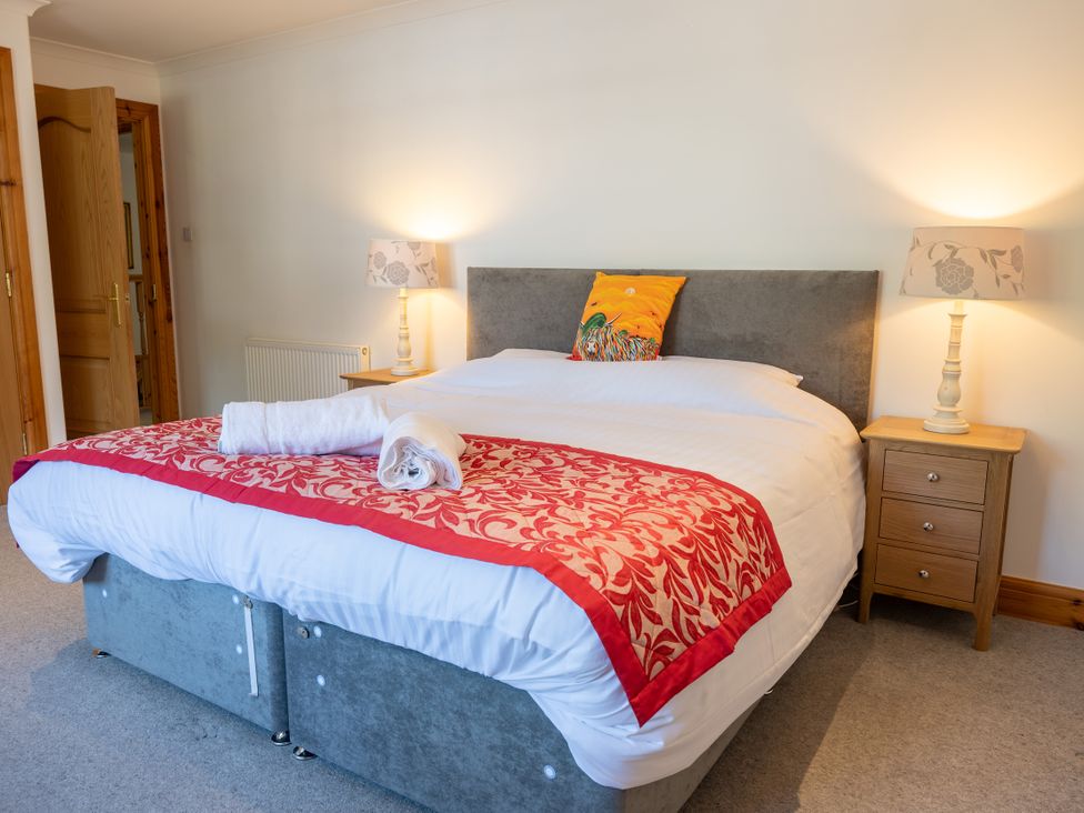A bedroom with a bed and bedside tables at Old Distillery Lodge