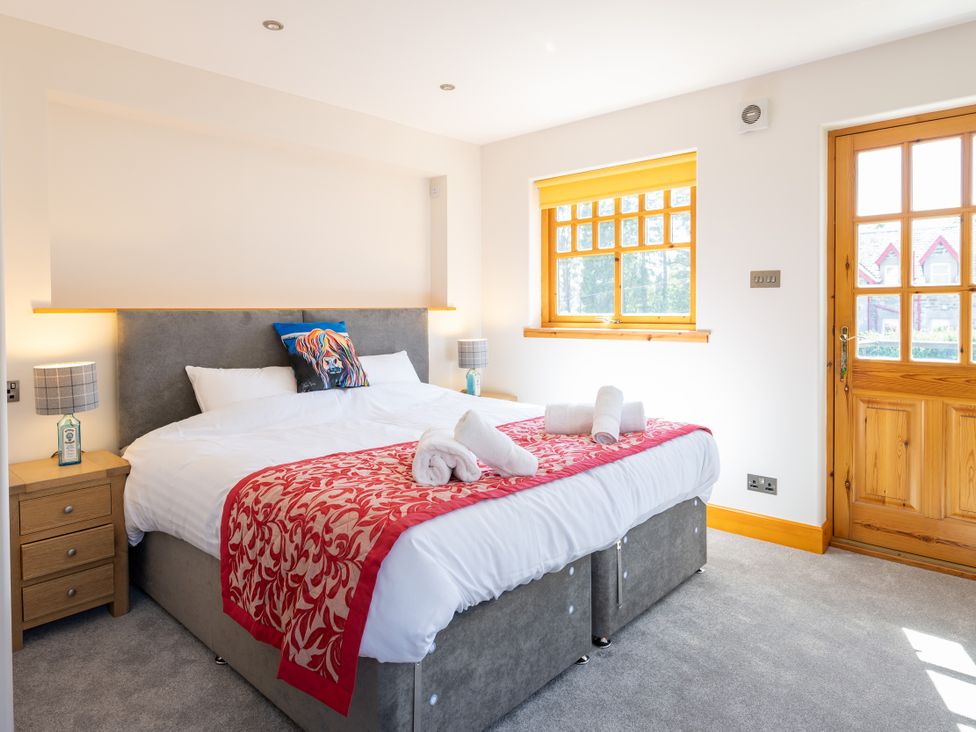 A bedroom with a bed and bedside table at Old Distillery Lodge