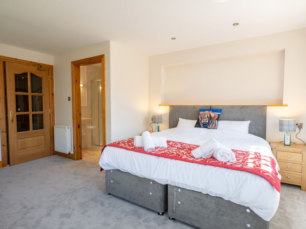 A bedroom with a bed and bedside tables at Old Distillery Lodge