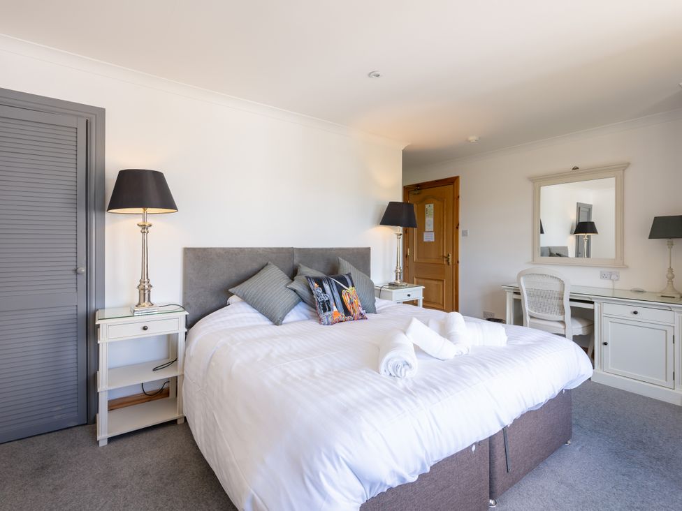 A bedroom with a bed and desk at Old Distillery Lodge