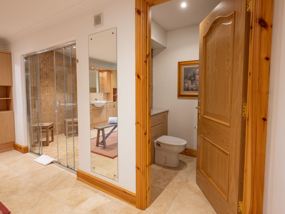 A bathroom with a toilet and sink at Old Distillery Lodge