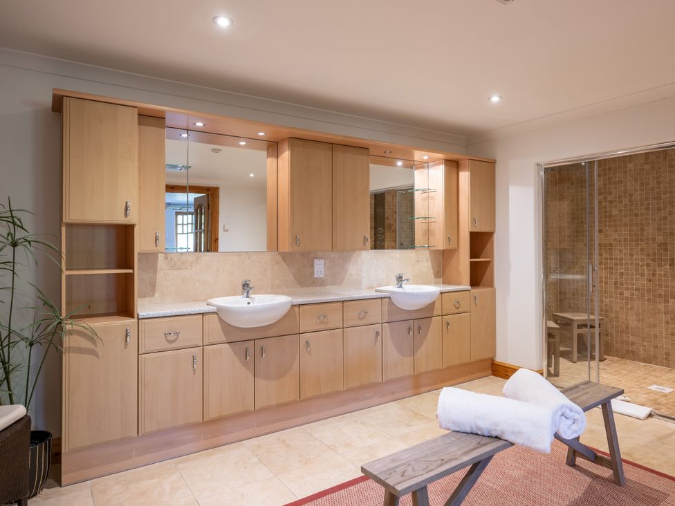 A bathroom with a sink and vanity cabinet at Old Distillery Lodge
