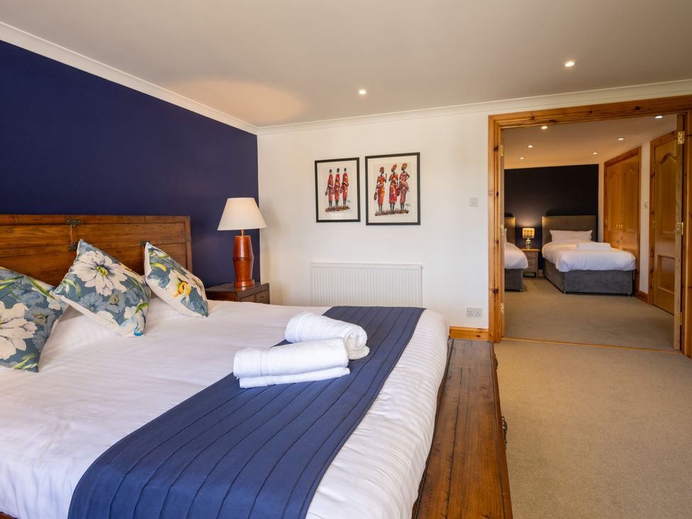 A bedroom with a bed and artwork at Old Distillery Lodge