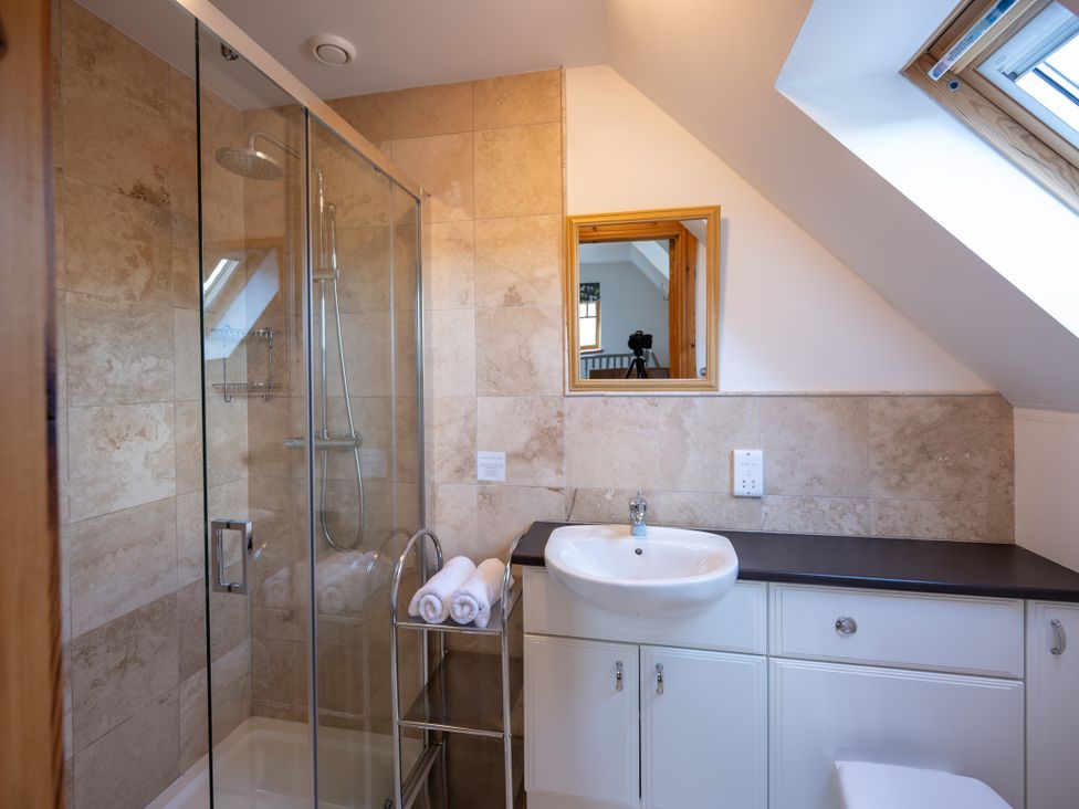 A bathroom with a shower and sink at Old Distillery Lodge