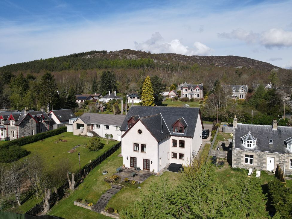 An aerial view of houses and gardens at Old Distillery Lodge in Kingussie