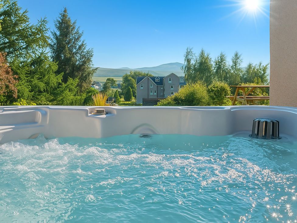 A hot tub with water in view at Old Distillery Lodge in Kingussie