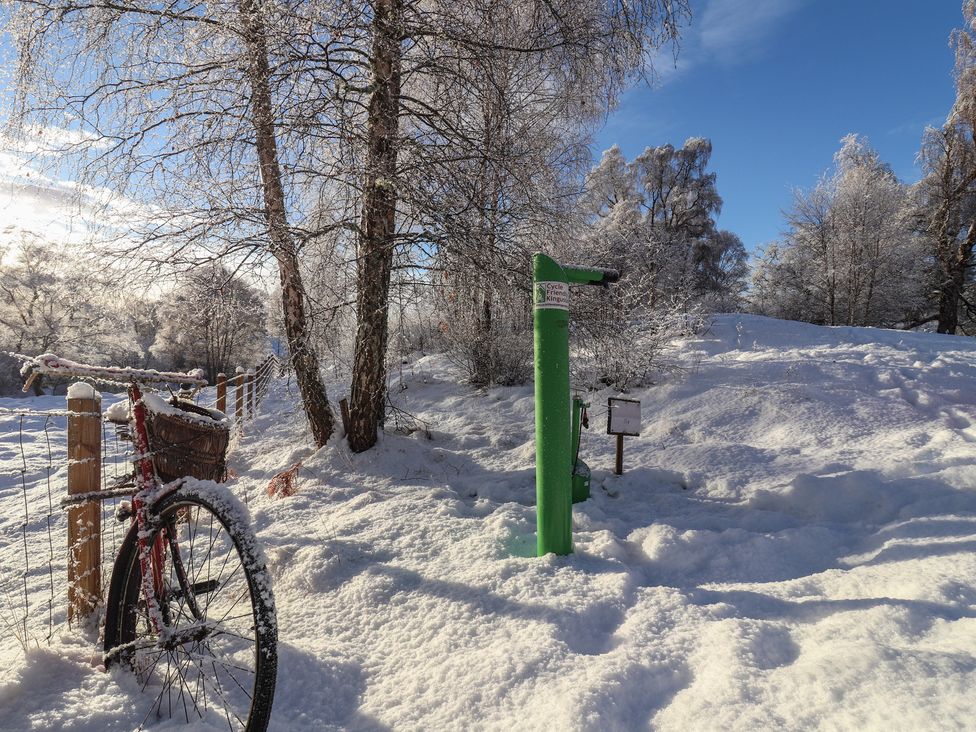 A bicycle and a pump in a snowy area at Old Distillery Lodge in Kingussie