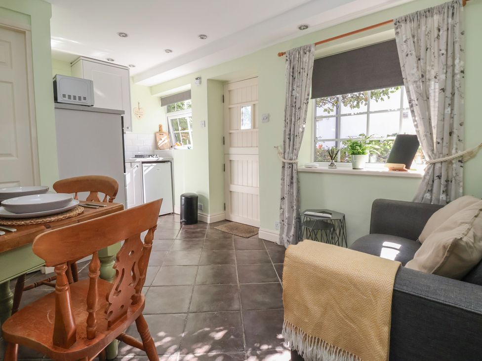 A kitchen with a table and chairs at Figgy Cottage in Ripon