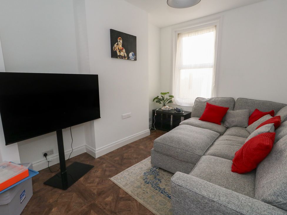 A living room with a sofa and television at Weymouth Seaside House in Weymouth