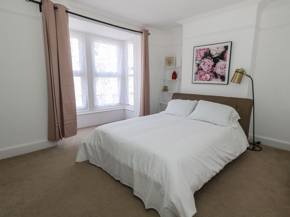 A bedroom with a bed and window at Weymouth Seaside House in Weymouth