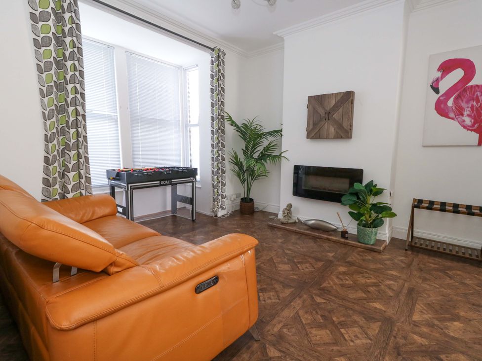 A living room with a foosball table and a plant at Weymouth Seaside House in Weymouth