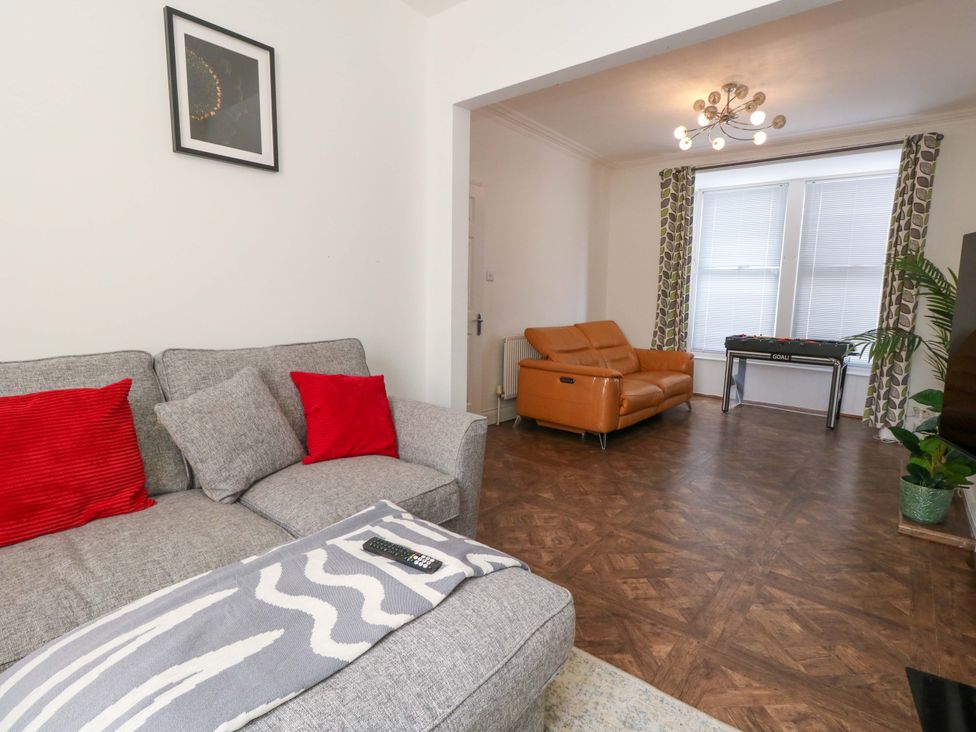 A living room with a sofa and armchair at Weymouth Seaside House in Weymouth