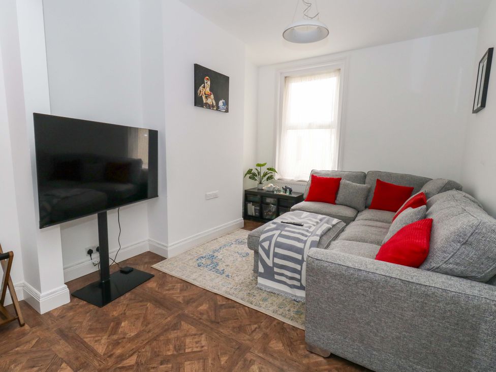 A living room with a sofa and television at Weymouth Seaside House in Weymouth