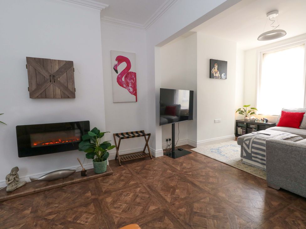 A living room with a couch and a television at Weymouth Seaside House in Weymouth