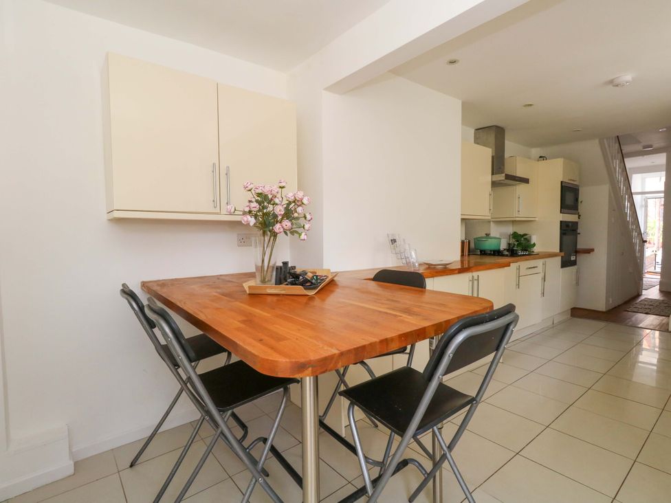 A kitchen with a table and chairs at Weymouth Seaside House in Weymouth