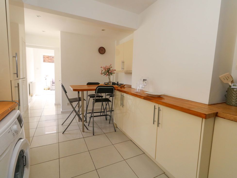 A kitchen with a table and chairs at Weymouth Seaside House in Weymouth