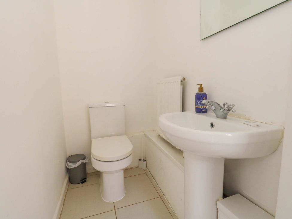 A bathroom with a toilet and sink at Weymouth Seaside House in Weymouth