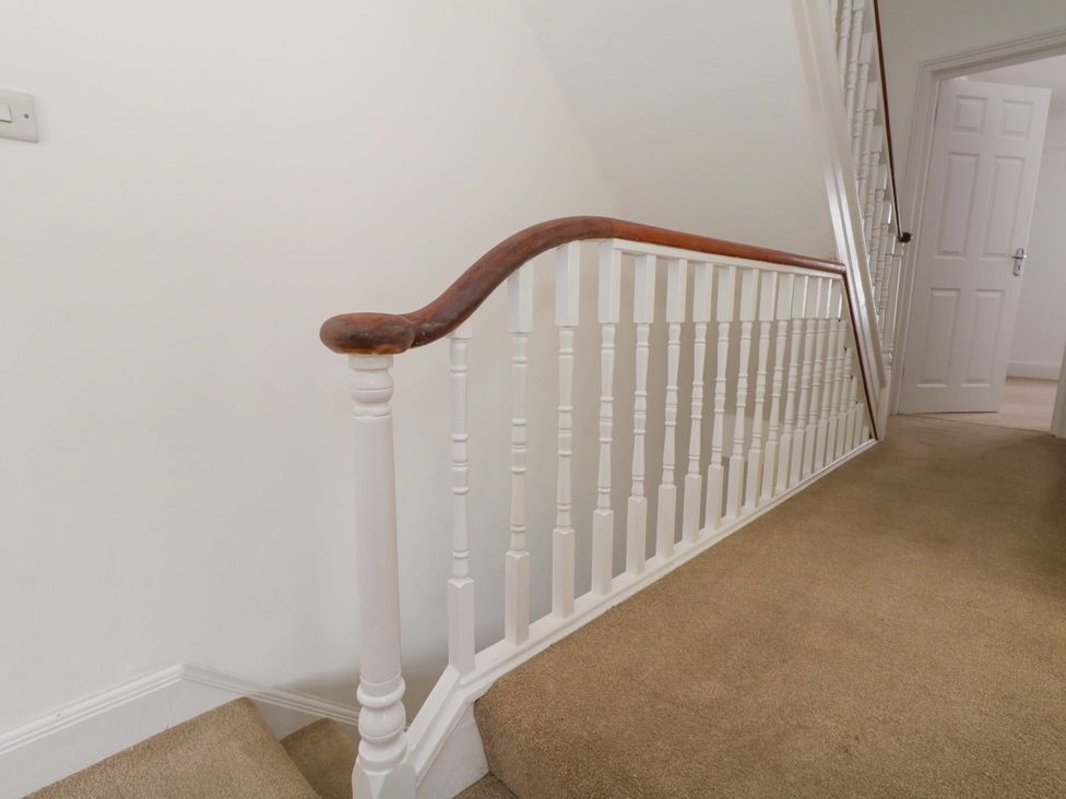 A staircase railing in a hallway at Weymouth Seaside House, Weymouth