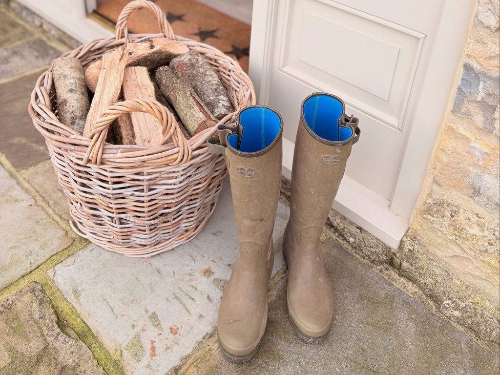 A basket of firewood and wellies at Angram Cottage Angram Grange near Thirsk