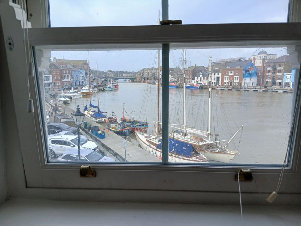 A view of boats and a canal from a window at Harbourside in Weymouth