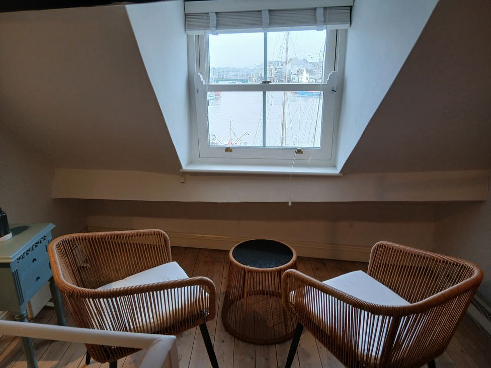 A snug area with two chairs and a table at Harbourside in Weymouth