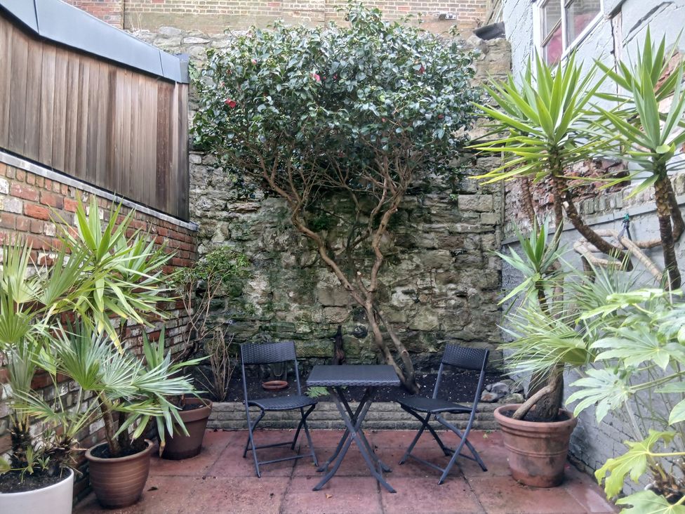 A garden with plants and a table and chairs at Harbourside in Weymouth