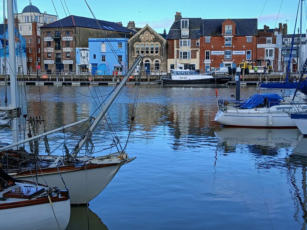 A view of boats and buildings along the harbor at Harbourside in Weymouth