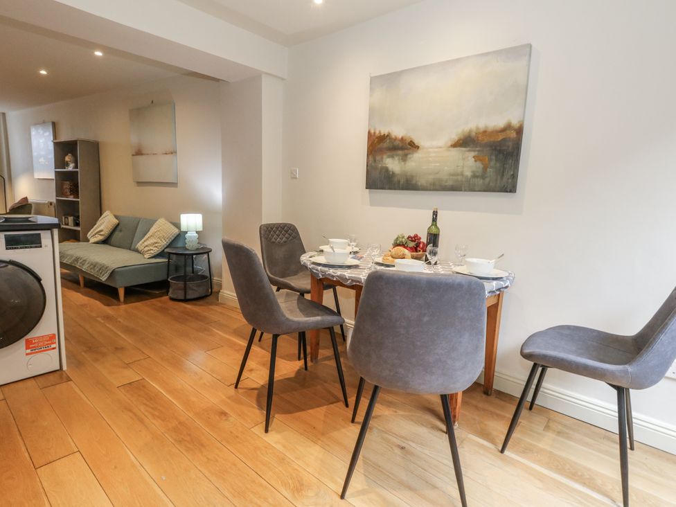 A dining room with a table set for a meal at Harbourside in Weymouth