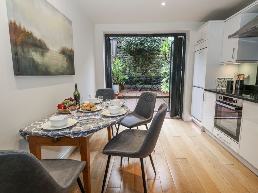 A kitchen with a table set for dining at Harbourside in Weymouth