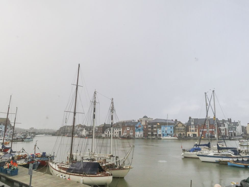 A view of boats in the water near houses at Harbourside in Weymouth