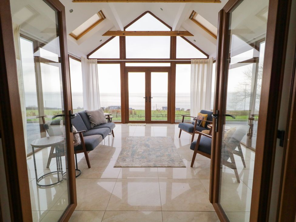 A conservatory with seating and a view at Ard Na Mara, Drung near Quigley's Point, County Donegal
