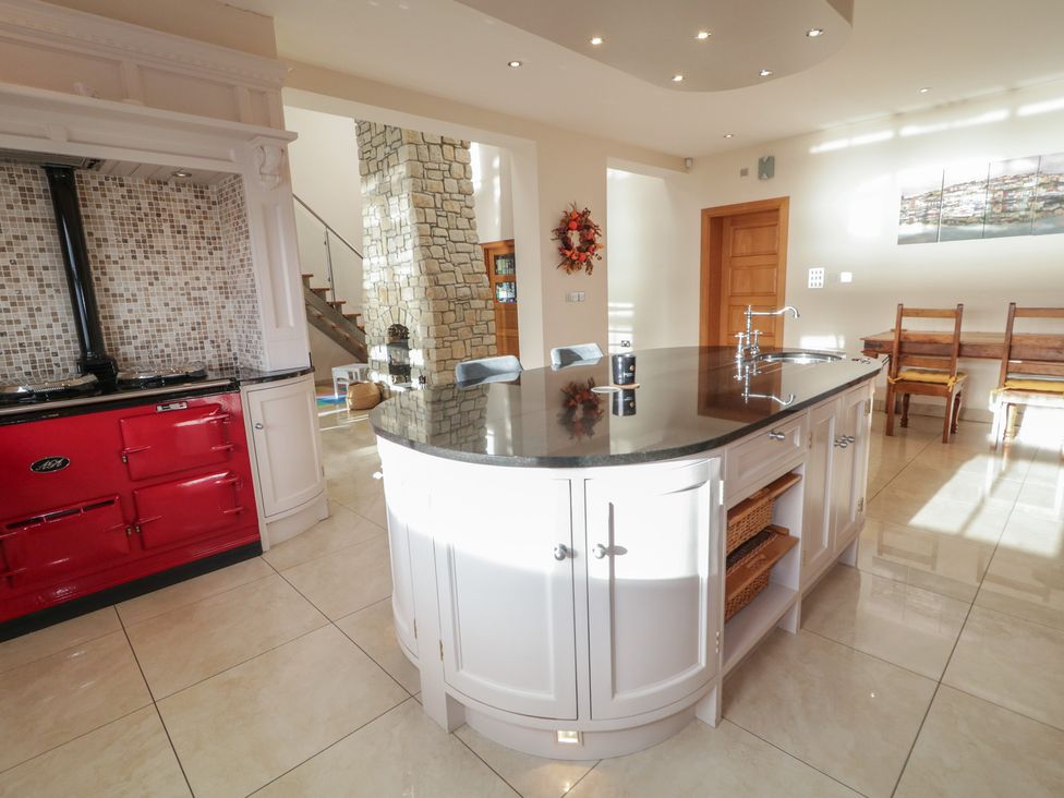 A kitchen with a red stove and island in Ard Na Mara Drung near Quigley's Point, County Donegal