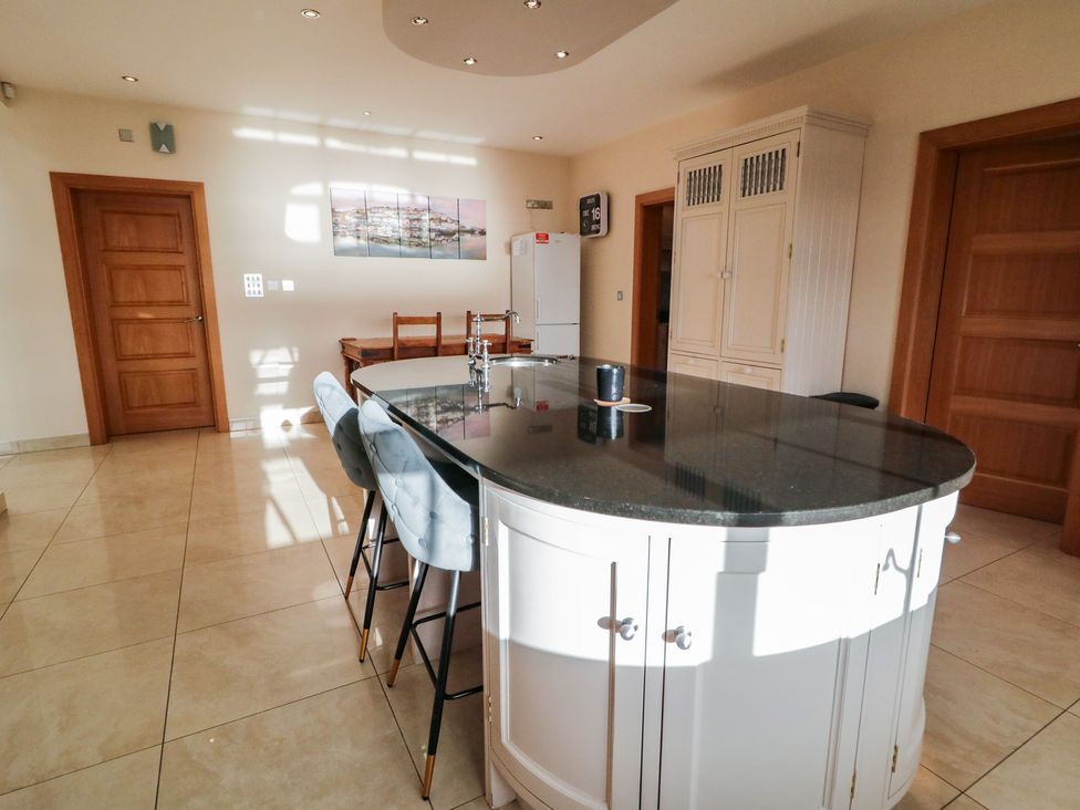 A kitchen with an island and stools at Ard Na Mara, Drung near Quigley's Point, County Donegal