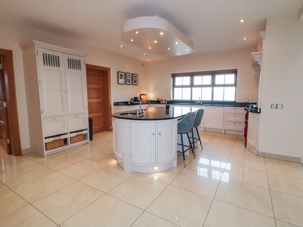 A kitchen with an island and cabinets at Ard Na Mara in Drung near Quigley's Point, County Donegal