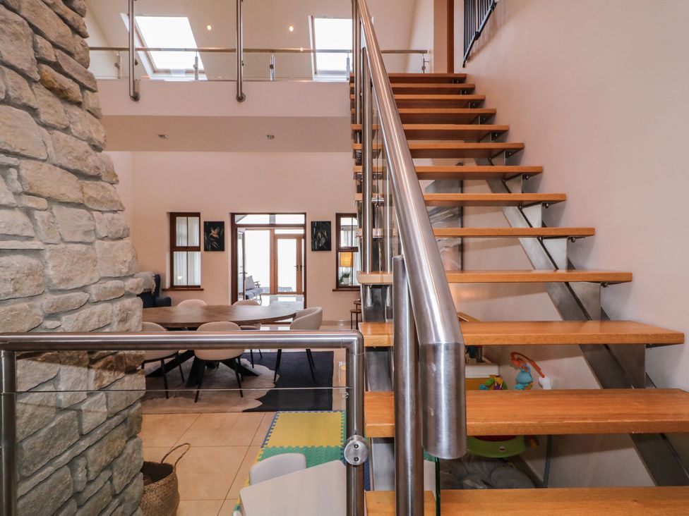 Stairs leading to upper floor with dining area visible at Ard Na Mara Drung near Quigley's Point County Donegal