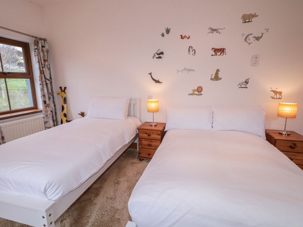 A bedroom with two beds and animal wall decor at Ard Na Mara, Drung near Quigley's Point, County Donegal