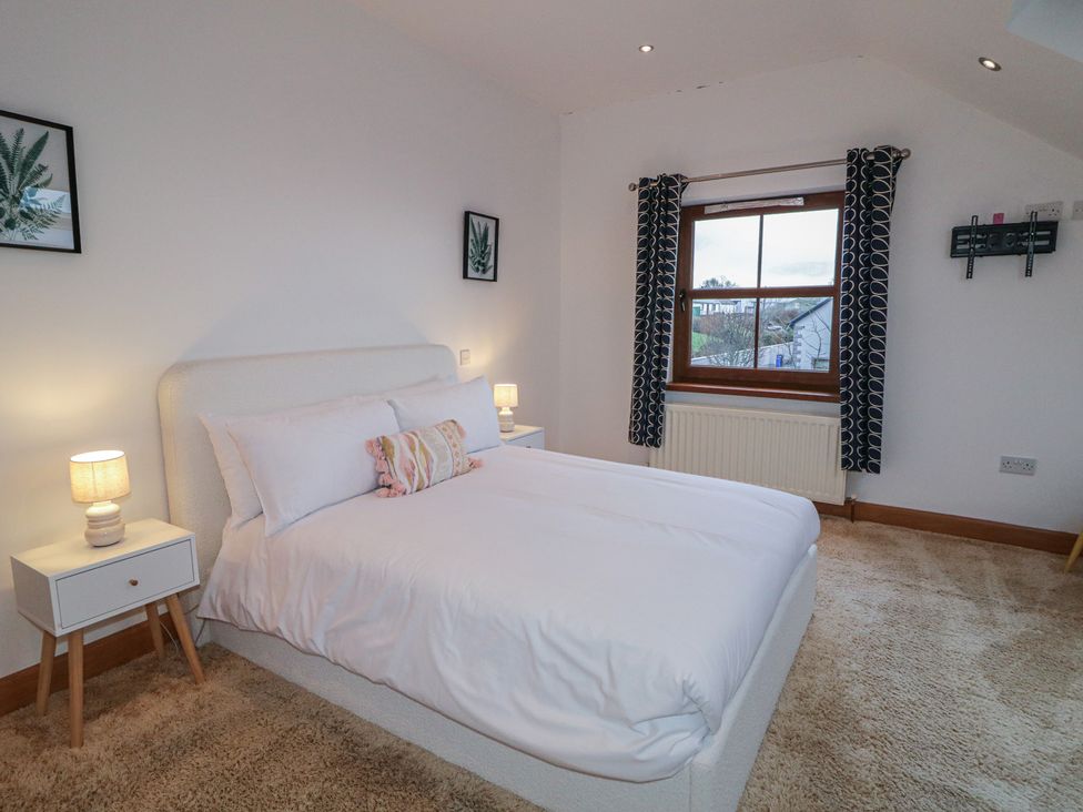 A bedroom with a bed and nightstand at Ard Na Mara in Drung near Quigley's Point, County Donegal