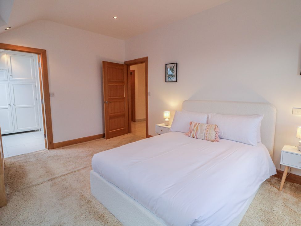 A bedroom with a bed and nightstands at Ard Na Mara, Drung near Quigley's Point, County Donegal