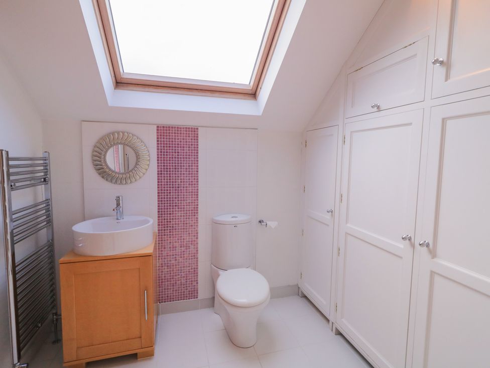 A bathroom with a sink, toilet and a towel radiator at Ard Na Mara in Drung near Quigley's Point, County Donegal