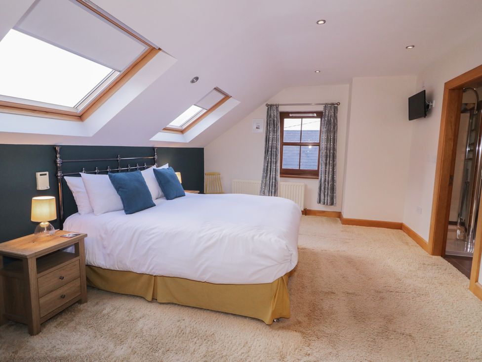 A bedroom with a double bed and a nightstand at Ard Na Mara Drung near Quigley's Point County Donegal