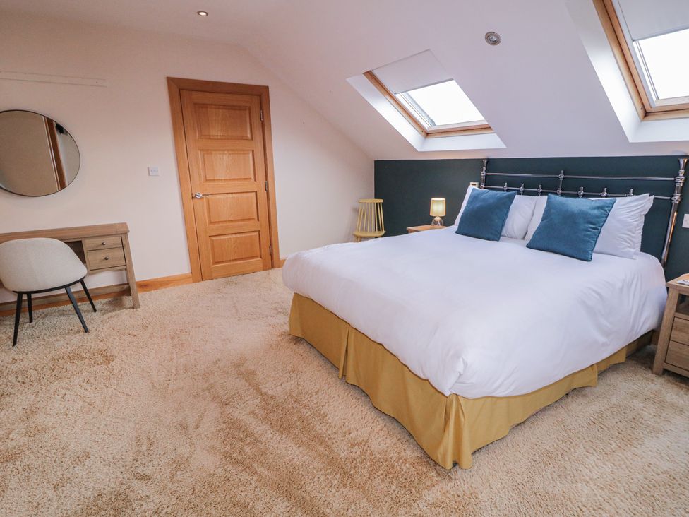 A bedroom with a bed and desk at Ard Na Mara in Drung near Quigley's Point, County Donegal