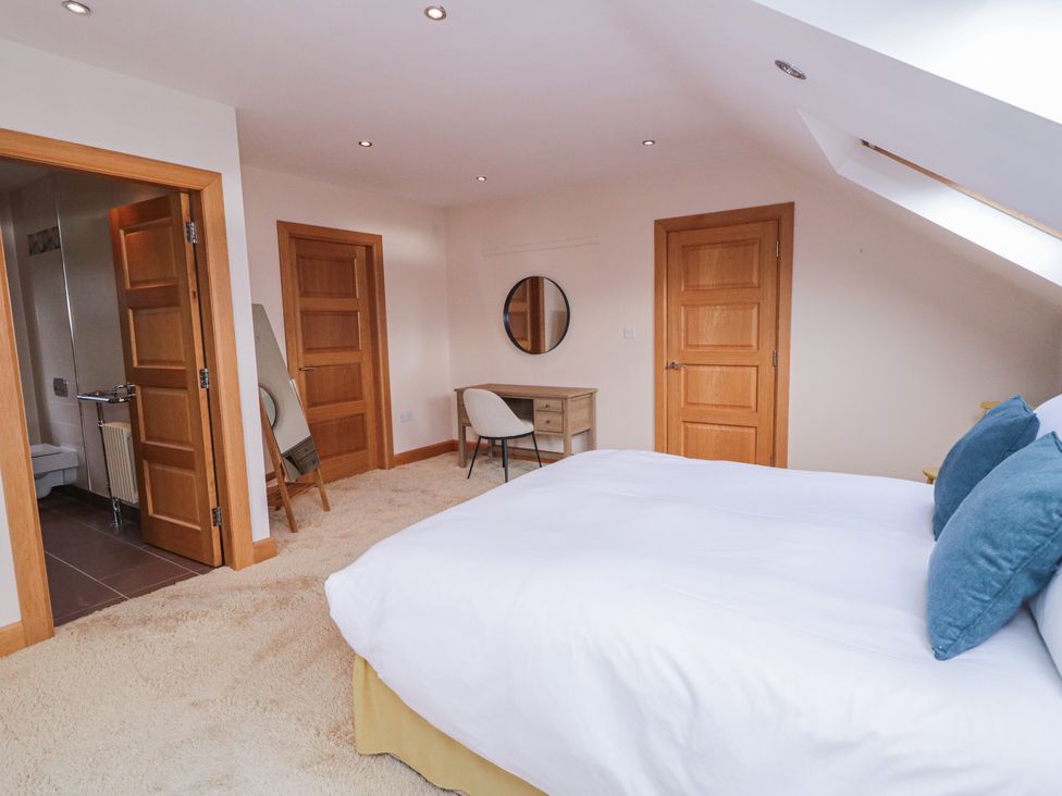 A bedroom with a bed and desk at Ard Na Mara Drung near Quigley's Point County Donegal