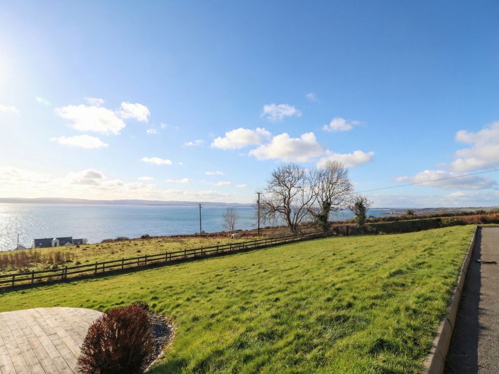 A view of the sea and grassland with trees at Ard Na Mara in Drung near Quigley's Point, County Donegal