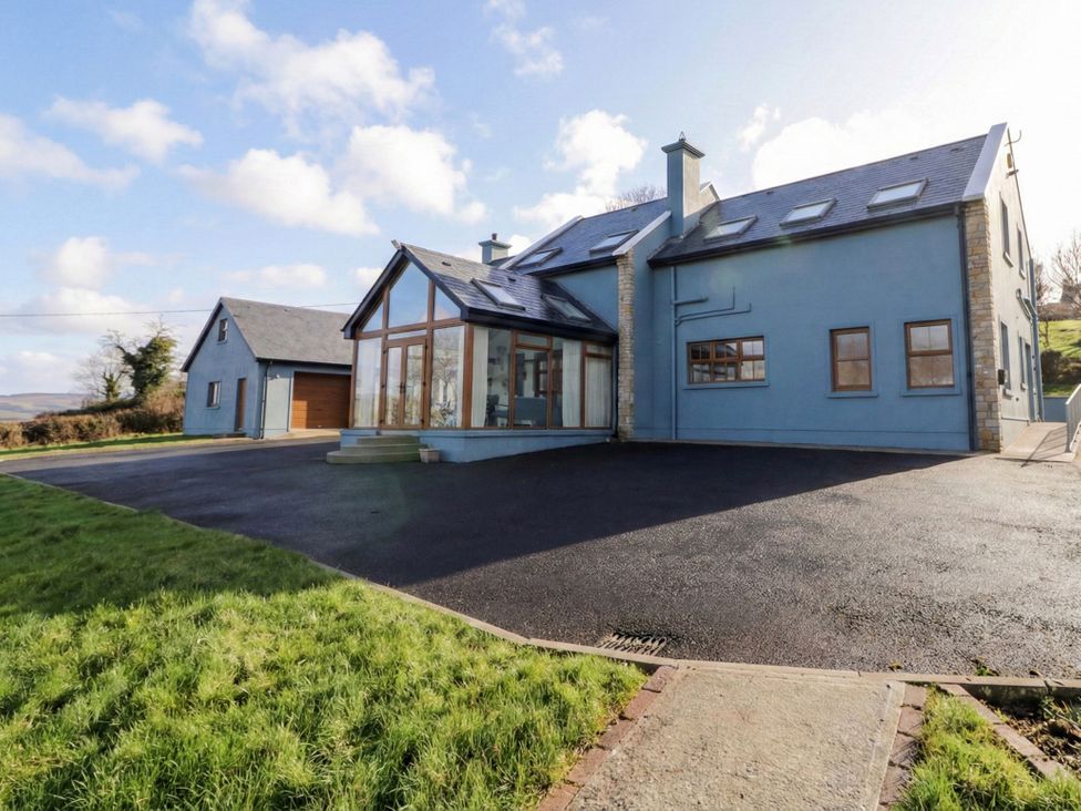 An outdoor view of a house with a garage and driveway at Ard Na Mara in Drung near Quigley's Point, County Donegal